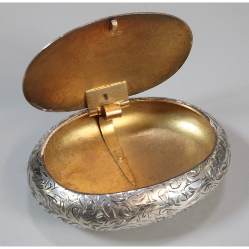 194 - George V silver snuff box with gilt interior, of engraved foliate pebble form. By Henry Williamson L... 