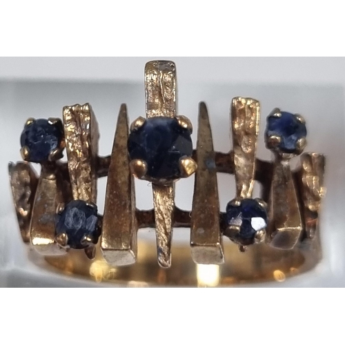 204 - 9ct gold modernist design and blue stone dress ring.  5g approx.  Size K1/2.   (B.P. 21% + VAT)