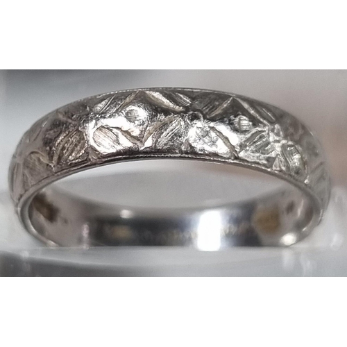 210 - Platinum engraved wedding band.  4.8g approx.  Size L.  (B.P. 21% + VAT)