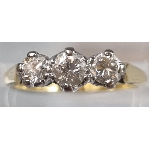 229 - 18ct gold three stone diamond ring.  3g approx.  Size M.  (B.P. 21% + VAT)