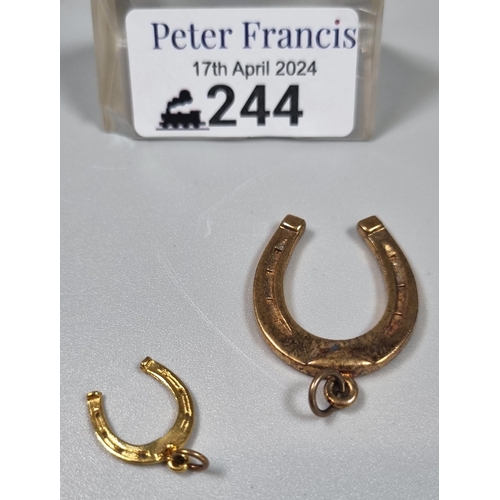 244 - Two 9ct gold horseshoe charms.  8.2g approx.  (B.P. 21% + VAT)