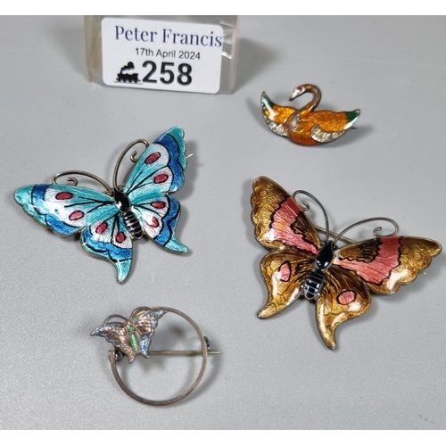 258 - Two silver and enamel brooches in the form of butterflies together with another enamel bird brooch a... 