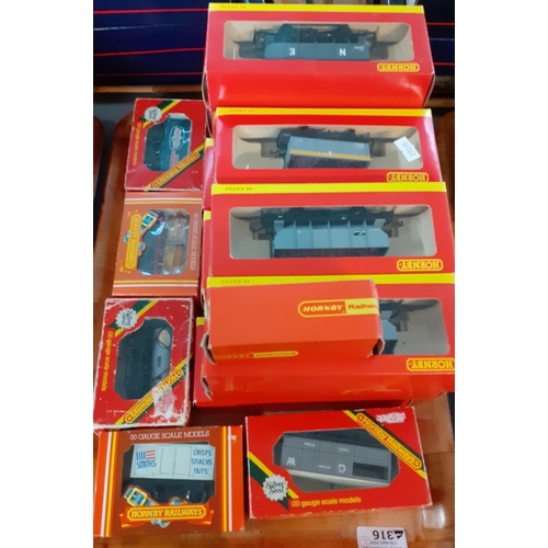 316 - Two trays with a collection of boxed Hornby OO gauge rolling stock to include: tenders, tankers, whe... 