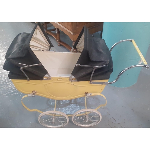 350 - 1960s Tri-ang double ended doll's pram with folding canopies and sprung frame.   (B.P. 21% + VAT)