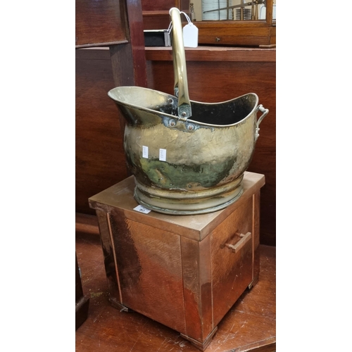 70 - Brass helmet shaped coal scuttle together with an Art Deco design copper two handled coal bin.  (2) ... 