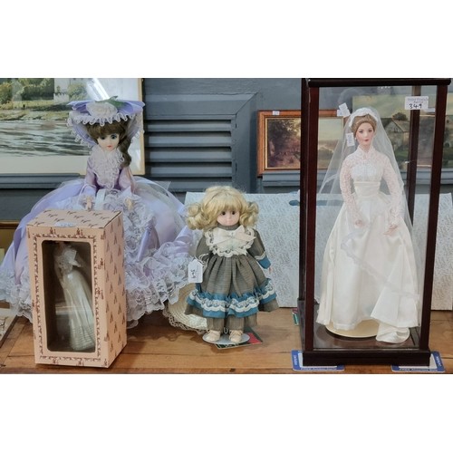 349 - Collection of Franklin Heirloom porcelain dolls, three in perspex and wooden cases together some oth... 