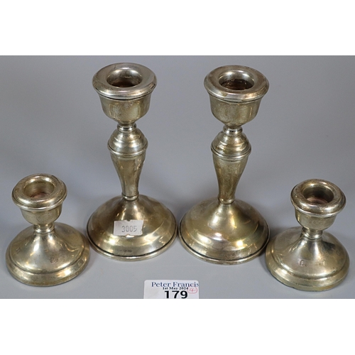 179 - Pair of silver baluster candle sticks together with a pair of silver dwarf candlesticks.  Both with ... 