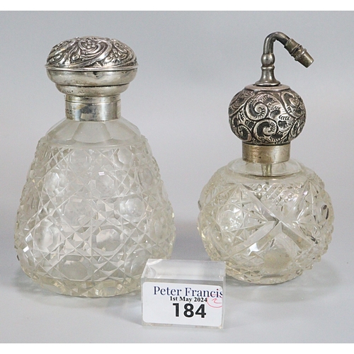 184 - Silver topped and cut glass ladies scent bottle with repoussé decoration together with another simil... 