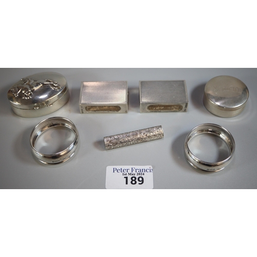 189 - Box of silver to include: two napkin rings, two silver boxes one decorated with jockey and racehorse... 