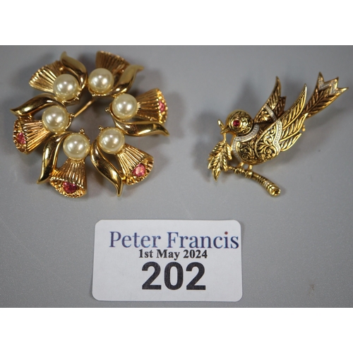 202 - Yellow metal brooch in the form, of a bird together with another gold finish floral and pearl design... 