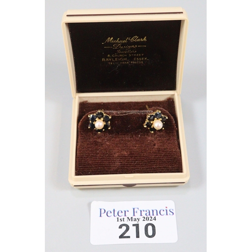 210 - Pair of 9ct gold pearl and sapphire flowerhead rings.  2.6g approx.   (B.P. 21% + VAT)