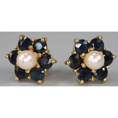 210 - Pair of 9ct gold pearl and sapphire flowerhead rings.  2.6g approx.   (B.P. 21% + VAT)