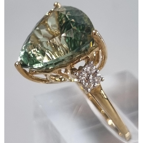 229 - 9ct gold 'Kiwi' green topaz and white sapphire ring.  Sri Lankan origin.  14.275 carat weight.  Size... 