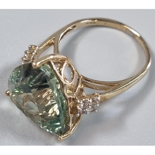 229 - 9ct gold 'Kiwi' green topaz and white sapphire ring.  Sri Lankan origin.  14.275 carat weight.  Size... 