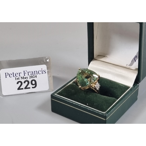 229 - 9ct gold 'Kiwi' green topaz and white sapphire ring.  Sri Lankan origin.  14.275 carat weight.  Size... 