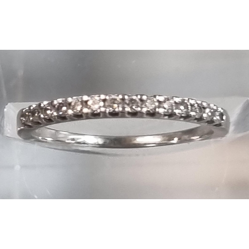 232 - Modern platinum and diamond half eternity ring marked 'Pravins', in Pravins ring box.  1.6g approx. ... 