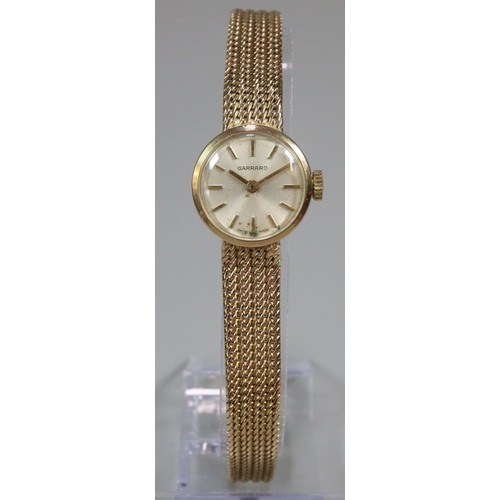 254 - 9ct gold Garrard ladies bracelet watch with satin face, having Baton numerals and integral mesh brac... 