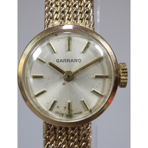 254 - 9ct gold Garrard ladies bracelet watch with satin face, having Baton numerals and integral mesh brac... 