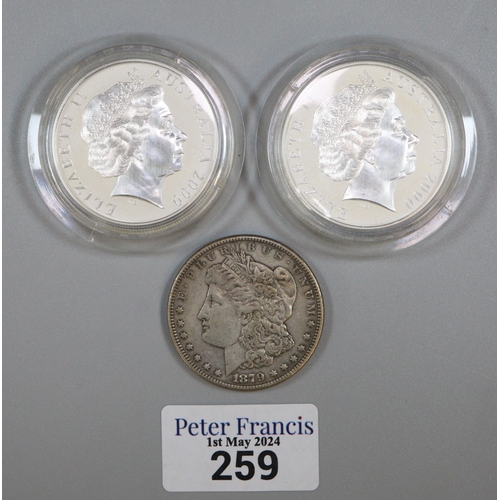 259 - Queen Elizabeth II silver one Dollar piece dated 2000 (2), together with an 1879 USA silver Dollar. ... 