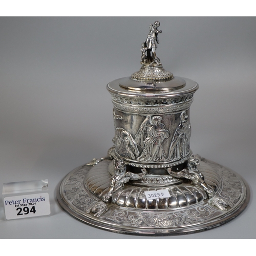 294 - An Elkington's Greek revival silverplated capstan shaped inkwell with figural cover, frieze of battl... 