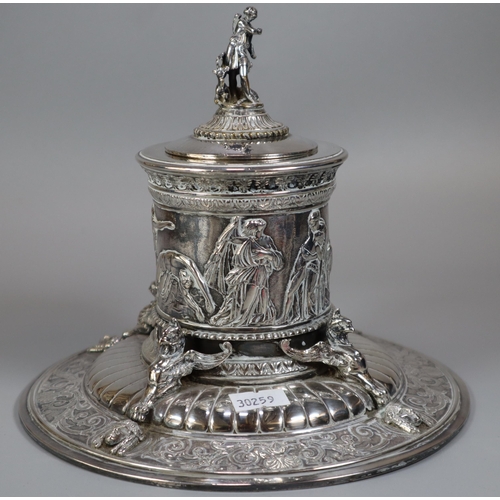 294 - An Elkington's Greek revival silverplated capstan shaped inkwell with figural cover, frieze of battl... 