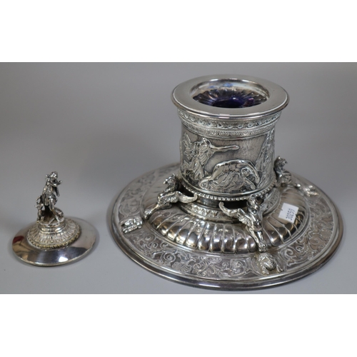 294 - An Elkington's Greek revival silverplated capstan shaped inkwell with figural cover, frieze of battl... 