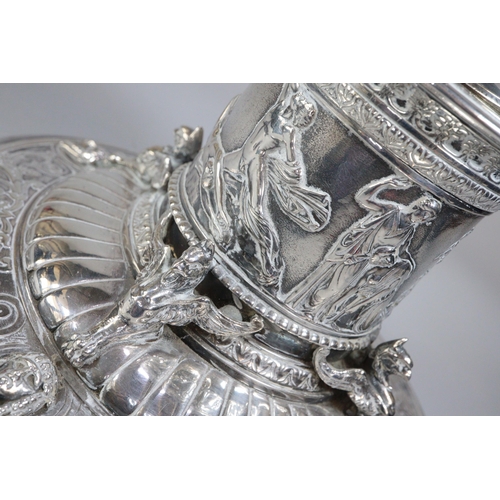 294 - An Elkington's Greek revival silverplated capstan shaped inkwell with figural cover, frieze of battl... 