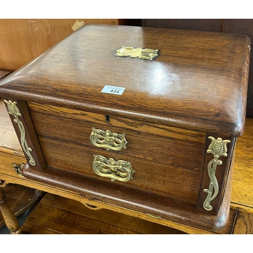 434 - Art Nouveau oak cutlery box with brass organic design mounts, the interior revealing part silver pla... 