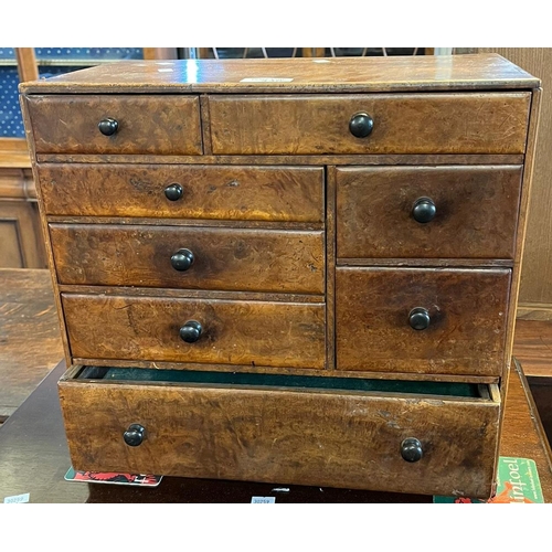 446 - 19th century maple table top collector's cabinet, having an arrangement of eight drawers with staine... 