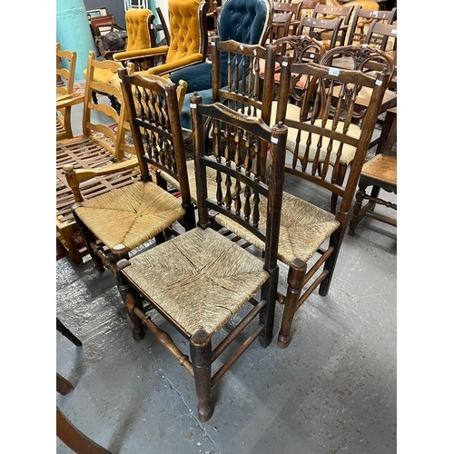 457 - Four similar Lancashire style spindle back chairs with rush seats.  (4)   (B.P. 21% + VAT)