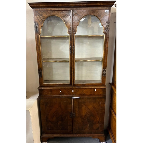 473 - 18th century style walnut and simulated walnut two door glazed bookcase of narrow proportions.  92x2... 