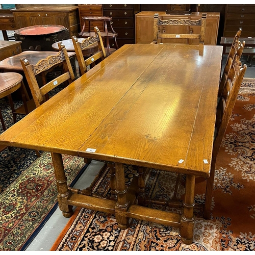 481 - Tudor Oak Furniture, a good quality oak dining table on baluster turned legs and central and side st...