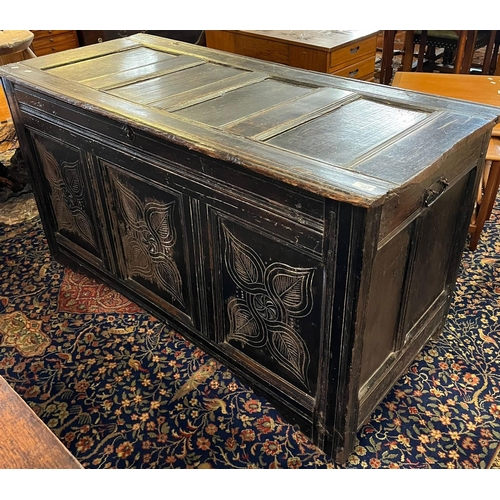 487 - 18th century stained oak coffer, the hinged moulded top above three foliate panels on associate cast... 