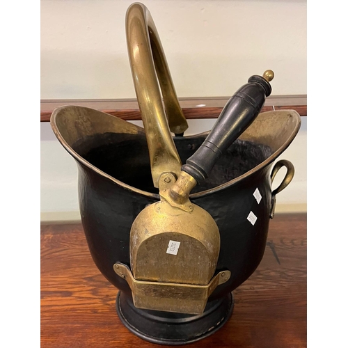 490 - Brass helmet shaped coal scuttle with swing handle and shovel.  (B.P. 21% + VAT)