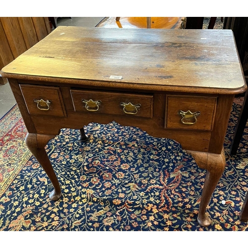 495 - 19th century oak lowboy, the moulded and shaped top above an arrangement of three drawers standing o... 