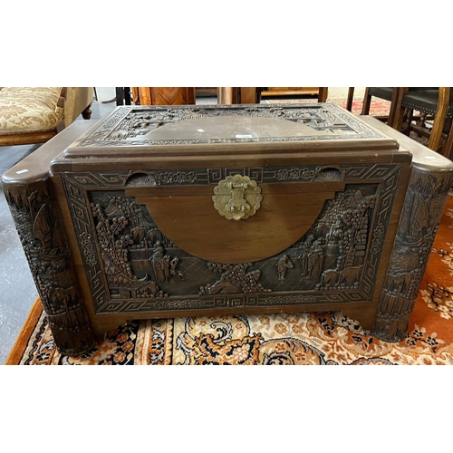 506 - 20th century heavily carved camphor wood chest, overall depicting figures, pagodas in a landscape.  ... 