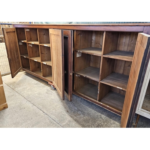 535 - (See Lot 525) Large early 20th century stained pine four door office/library cupboard with fitted in... 