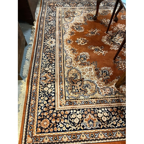 549 - Large traditional design machine made wool orange ground carpet with overall foliate decoration. Lab... 