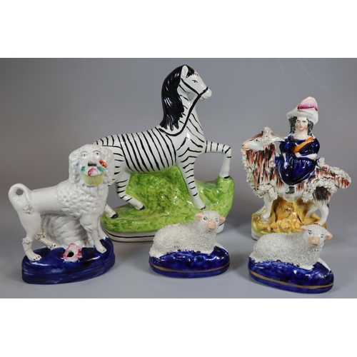 145 - Collection of Staffordshire and Staffordshire style figures to include: recumbent sheep. zebra, goat... 