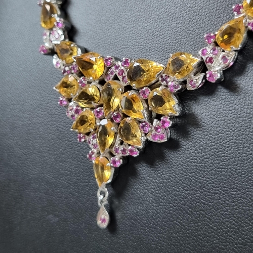 224 - Citrine and ruby set necklace in white metal together with a curb link chain with paste bow pendant.... 