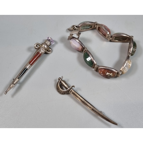 241 - Scottish hardstone dirk kilt pin, cutlass sword brooch and hardstone bracelet.  (3)  (B.P. 21% + VAT... 