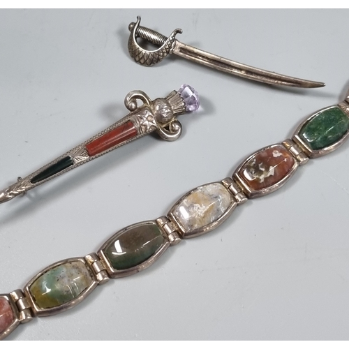 241 - Scottish hardstone dirk kilt pin, cutlass sword brooch and hardstone bracelet.  (3)  (B.P. 21% + VAT... 