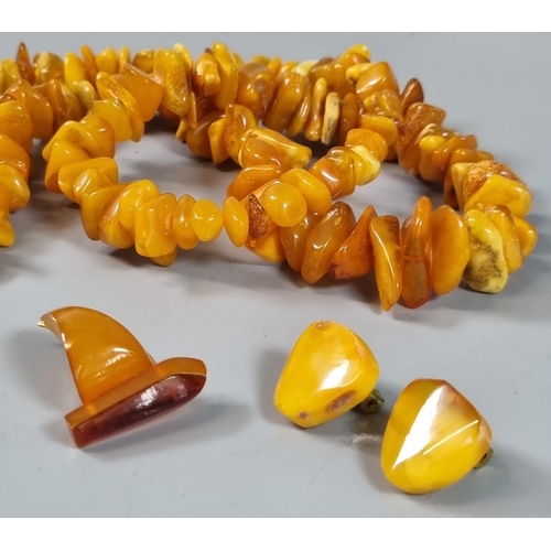 248 - Amber butterscotch necklace (60g approx.) together with a pair of amber clip-on earrings and a novel... 