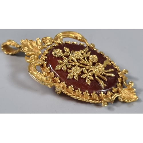 255 - Victorian carnelian pendant in floral hallmarked 9ct gold mount.  20g approx.  (B.P. 21% + VAT)