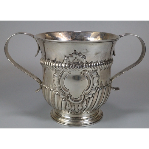 280 - 18th century silver two handled porringer, with fluted repoussé decoration and central vacant cartou... 