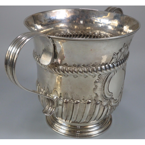 280 - 18th century silver two handled porringer, with fluted repoussé decoration and central vacant cartou... 