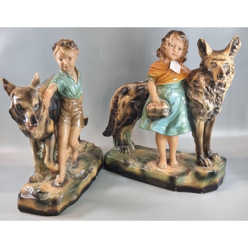 65 - Pair of Art Deco design chalk/plaster figure groups of dogs with a young girl and boy on naturalisti... 