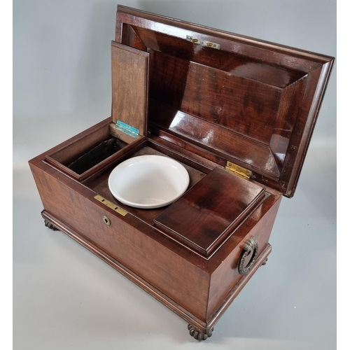 74 - 19th century mahogany sarcophagus shaped tea caddy, the interior revealing two sections with ceramic... 