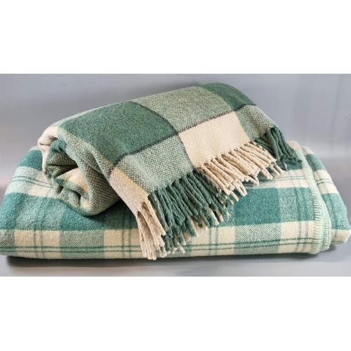 142 - Two similar green and white checked Welsh blankets.  (2)   (B.P. 21% + VAT)