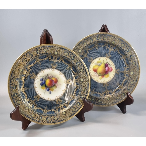 17 - Two similar Royal Worcester dessert dishes/plates, hand painted with fruits and foliage by A Shuck, ... 